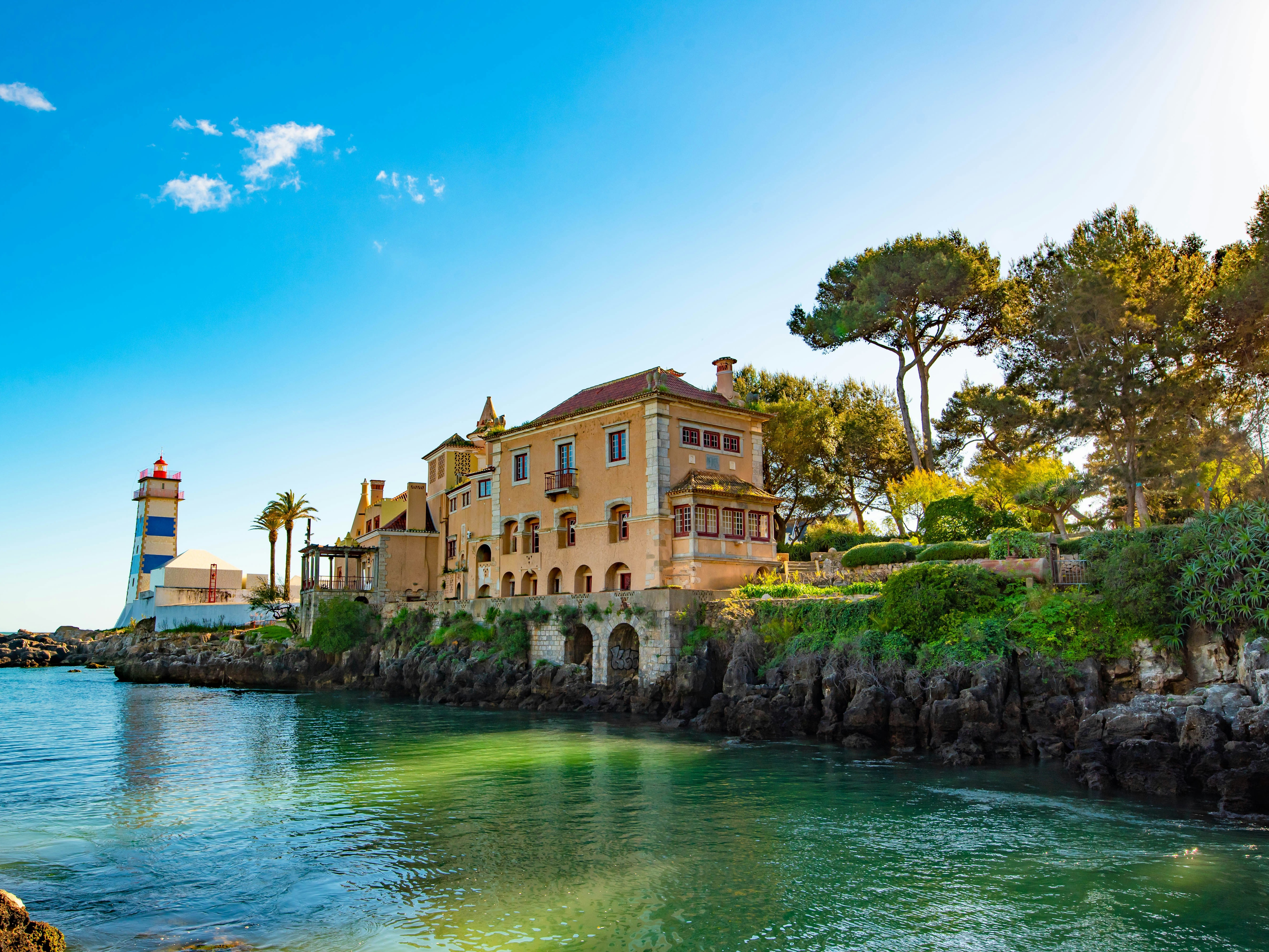 A beautiful building beside river under blue sky during daytime