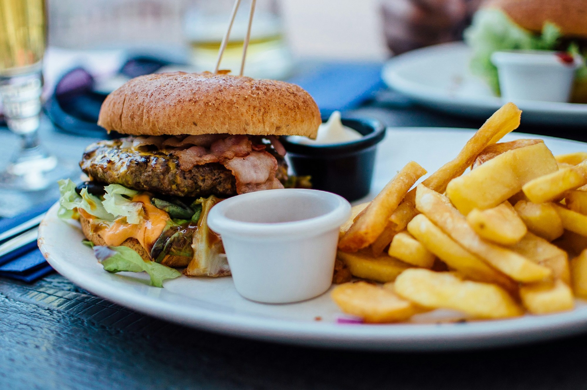 Meat burger with fries on a plate.