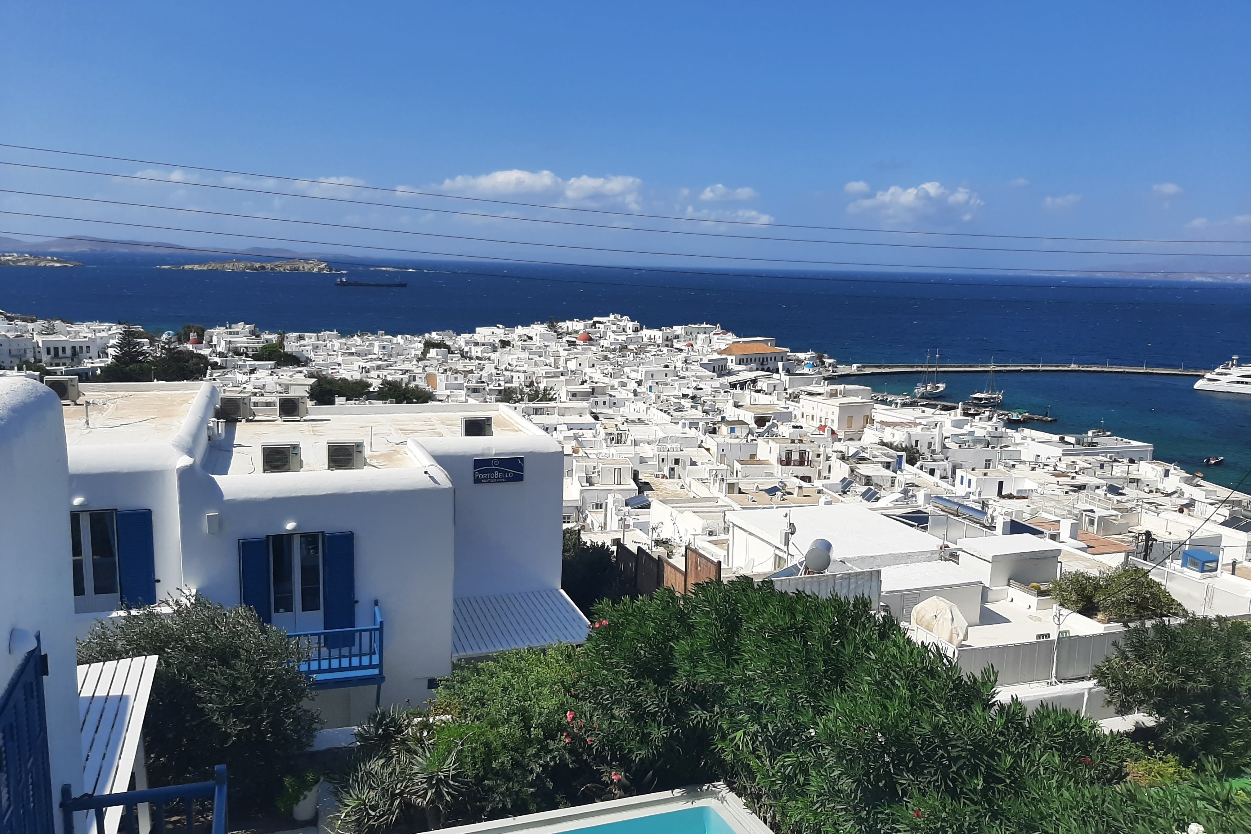 An aerial view of the city with white colored houses near the sea during the daytime.