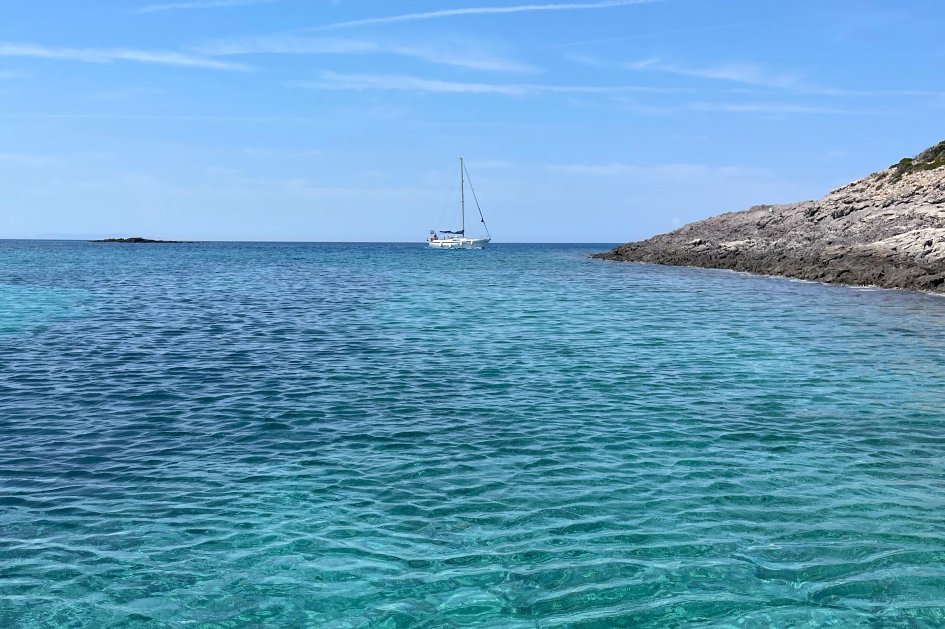 A picture of a boat sailing in the sea during the daytime.