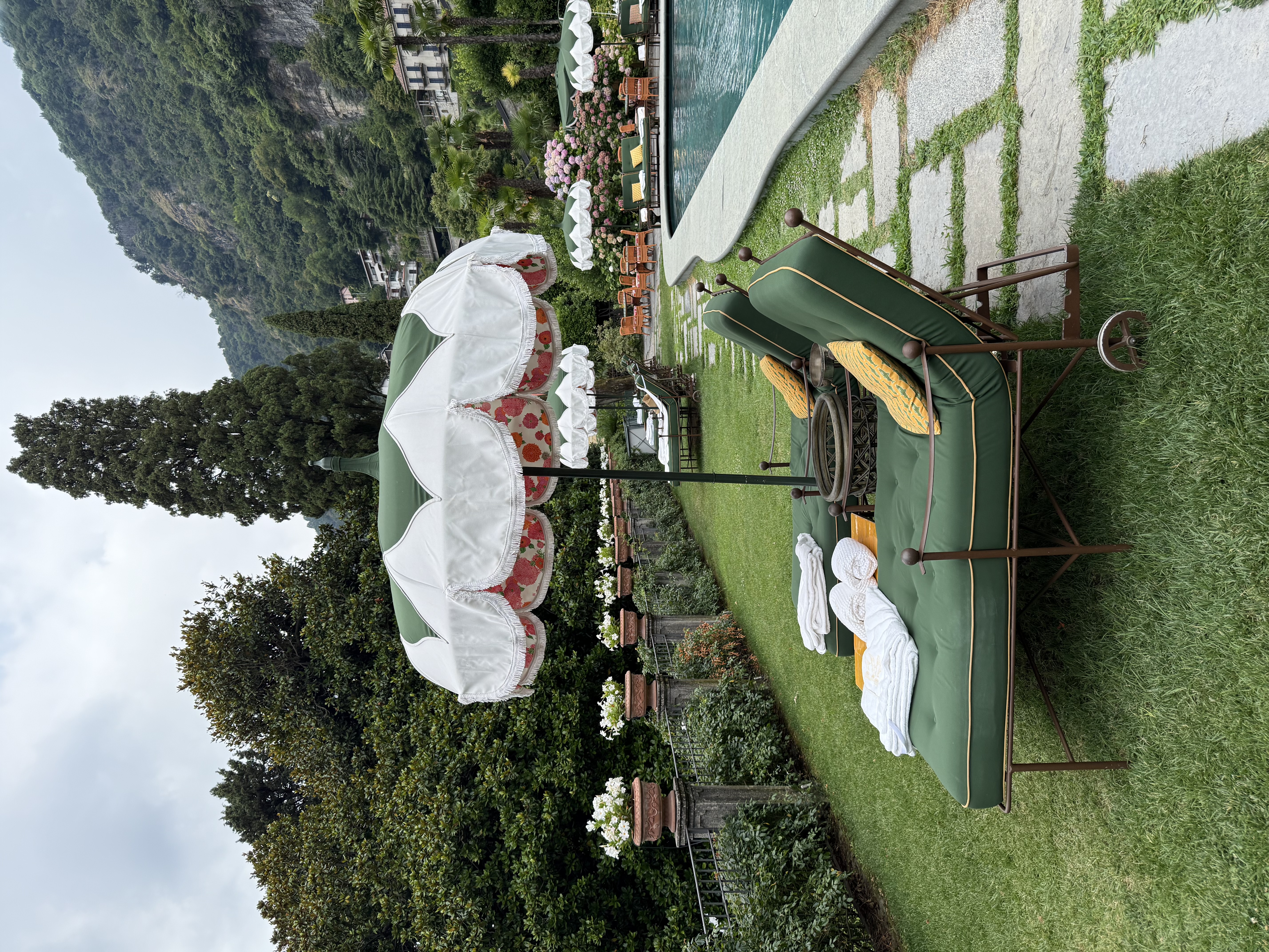Passalacqua villa terrace overlooking Lake Como with cypress trees.