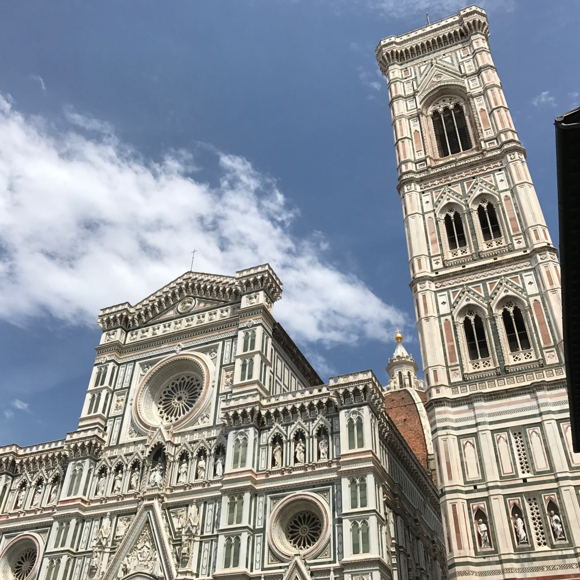 A low-angled view of a cathedral-like building under a blue sky during the daytime