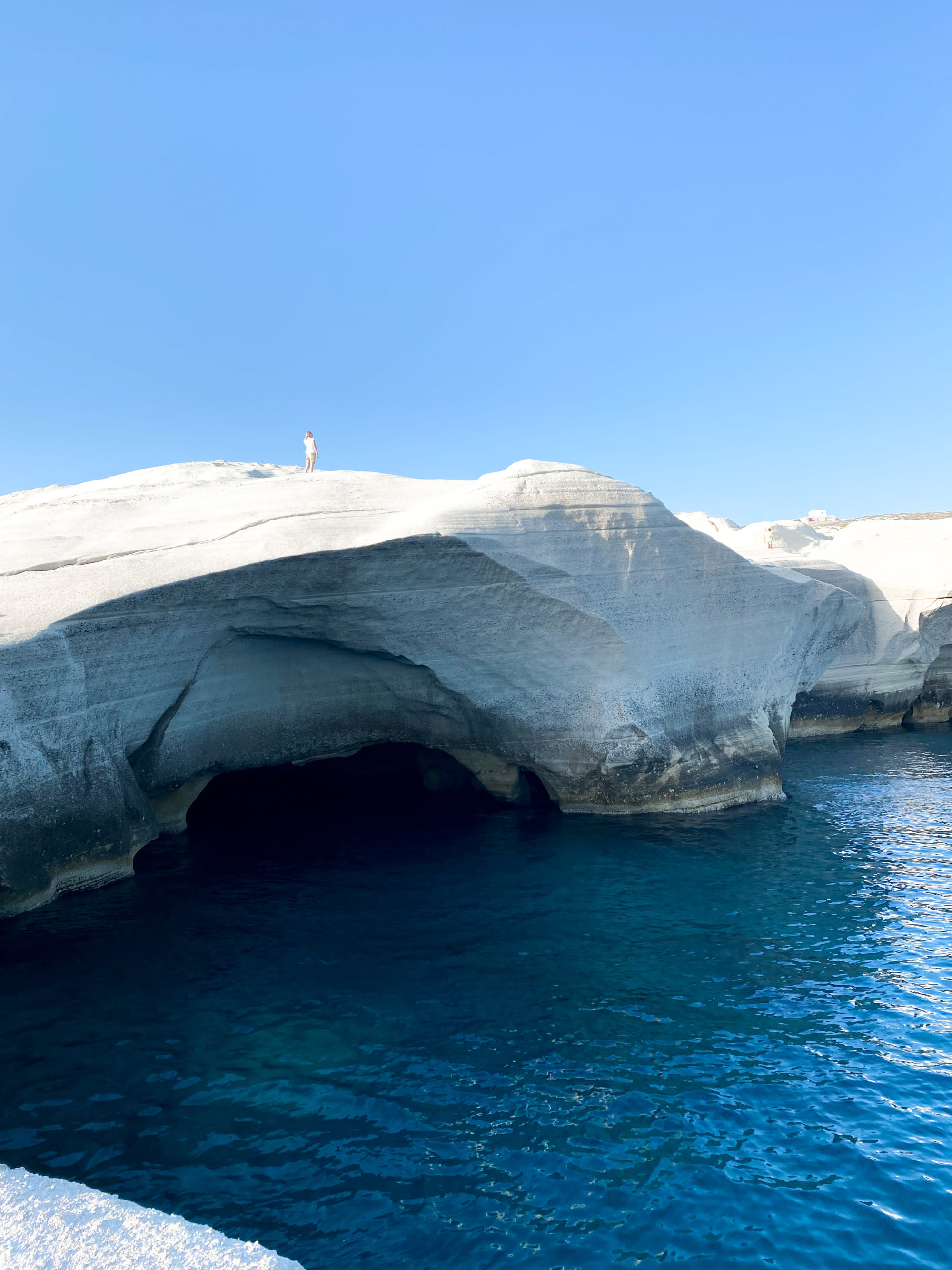 rock formation over the water on a clear day