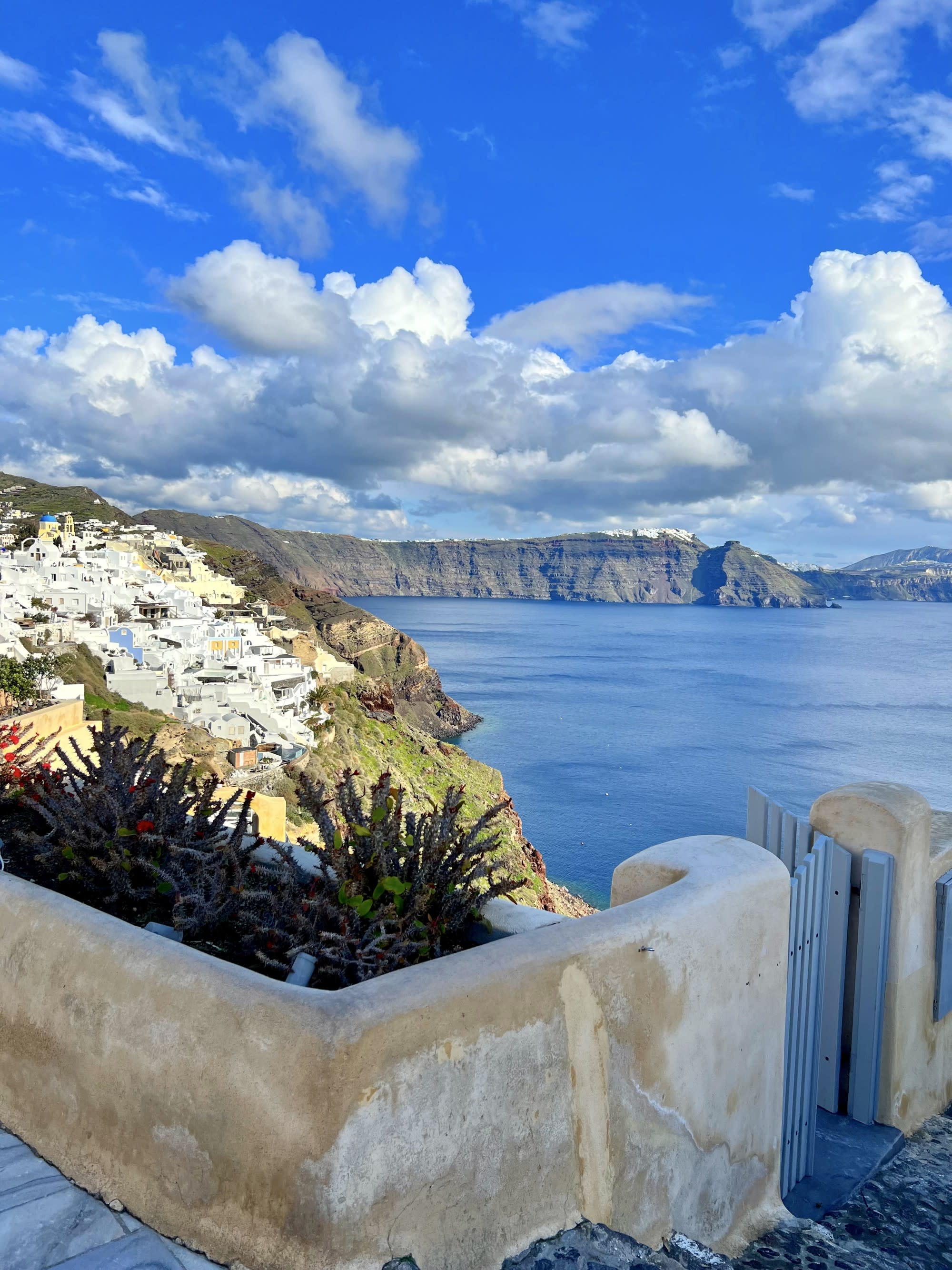 colorful houses on cliffside Greecian town