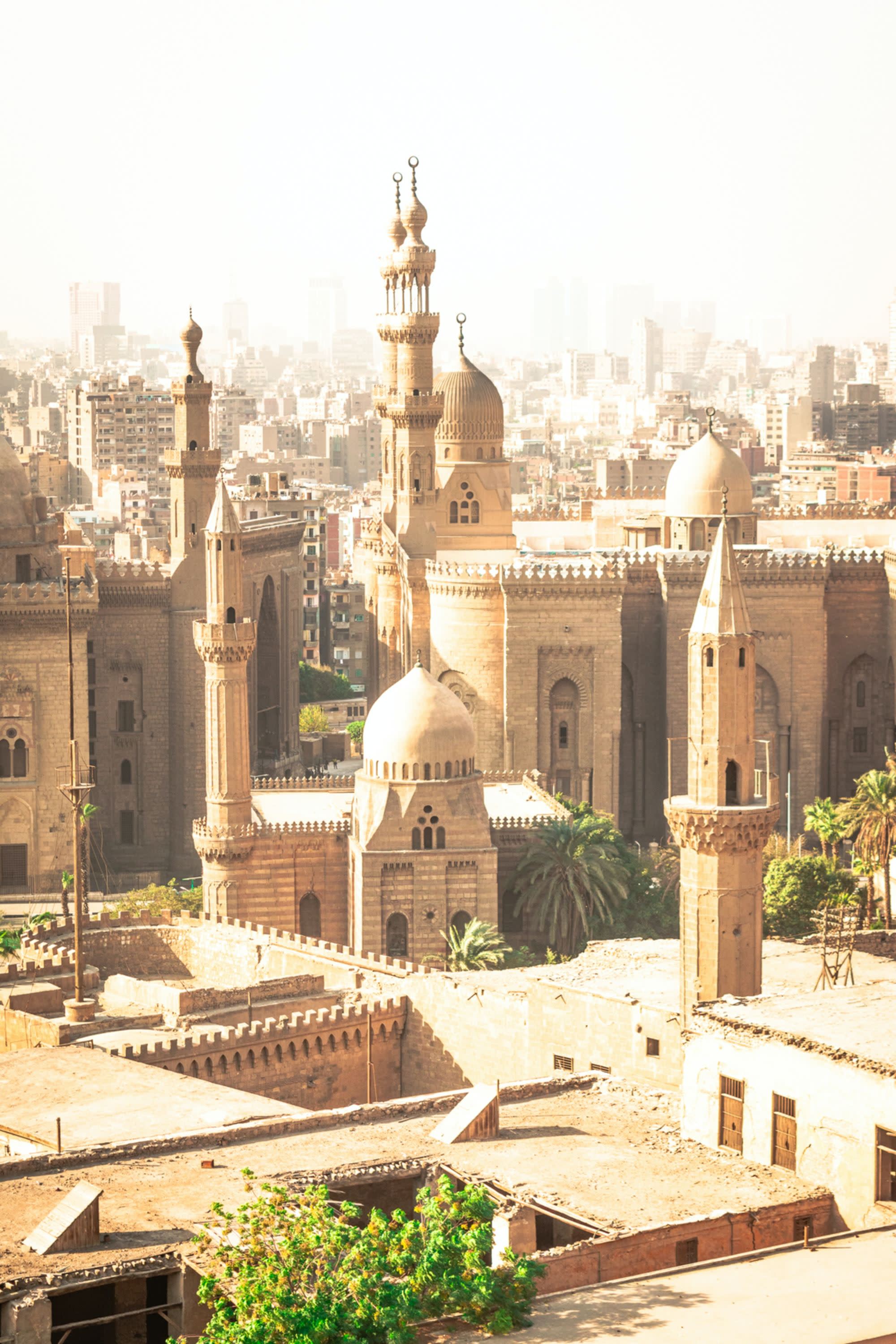 rooftop view of ancient desert city punctuates with tall steeples of mosques
