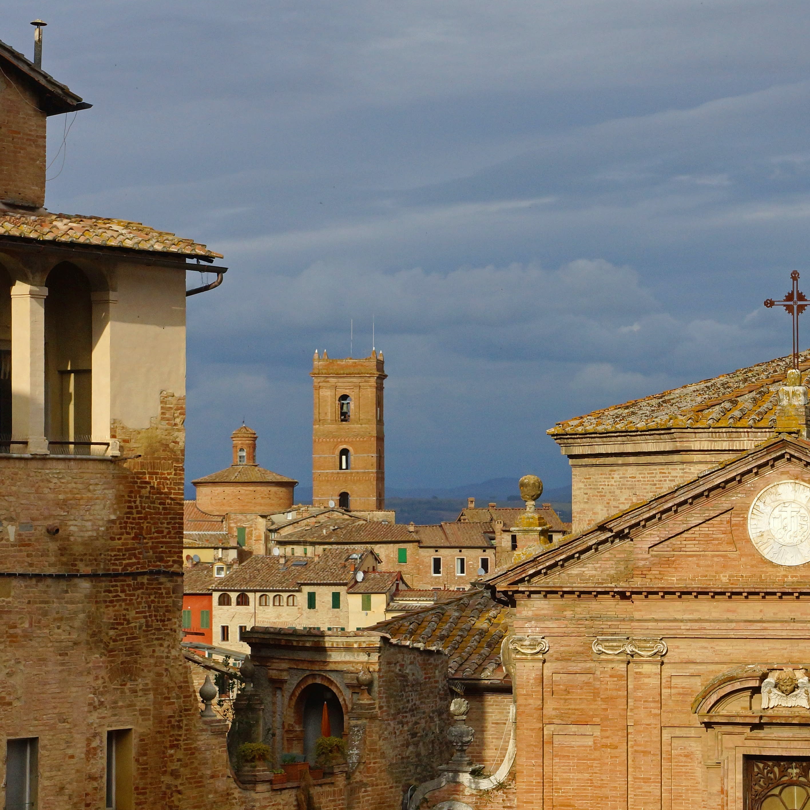 Skyline with tower in old city of Siena, Tuscany in Italy on a cloudy day.
