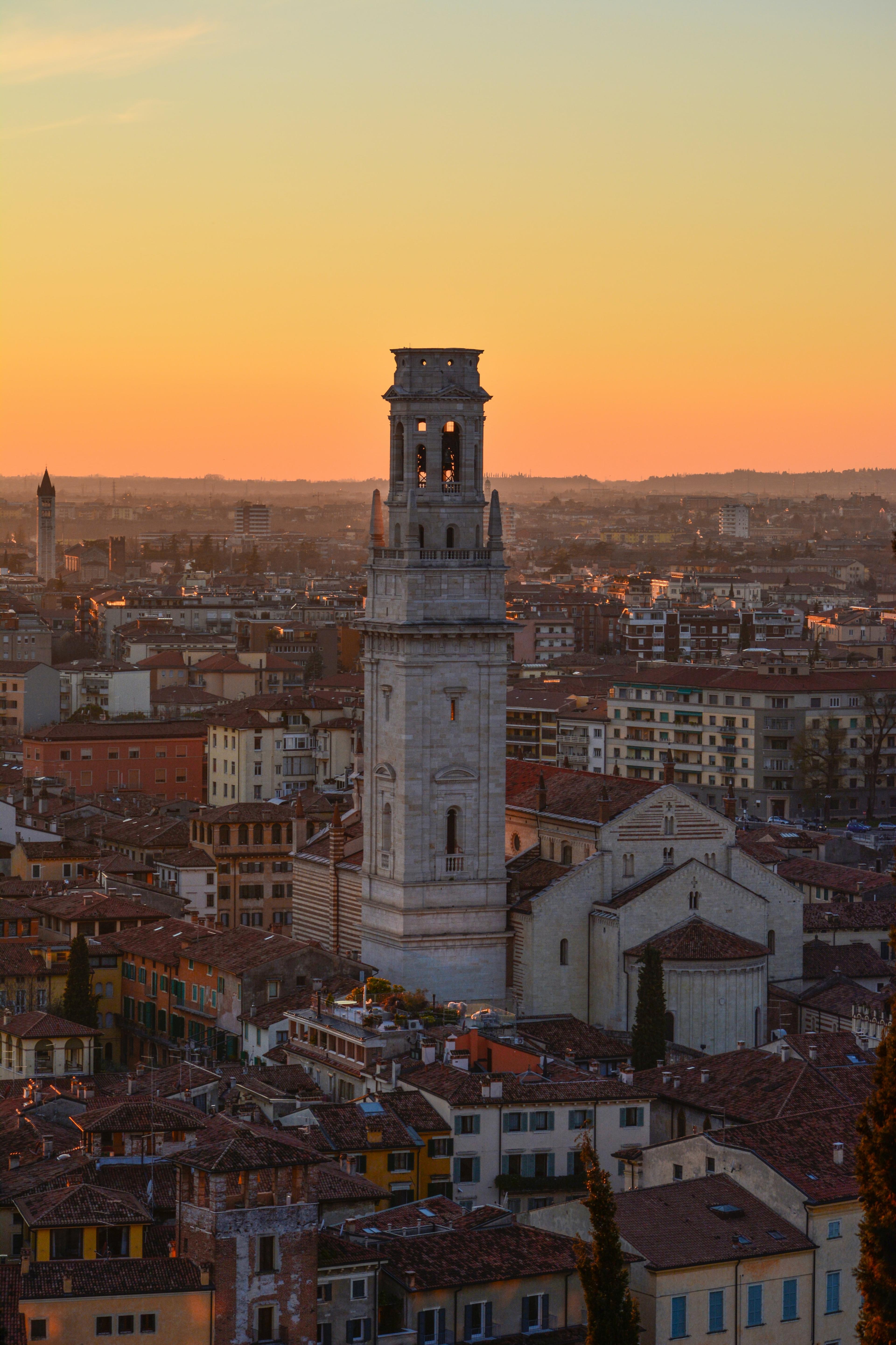 White concrete tower in city during sunset