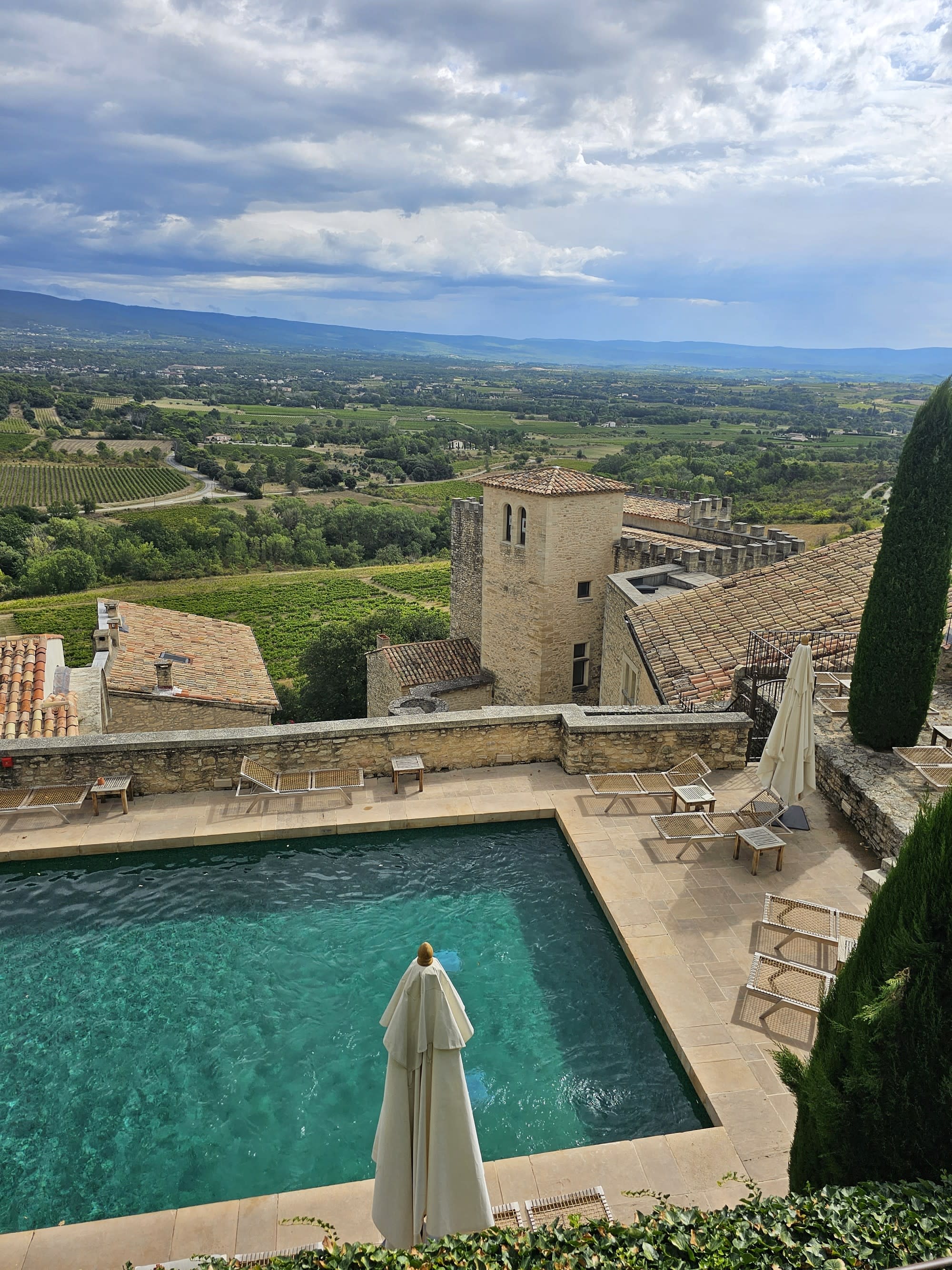 Aerial picture of pool with green landscape behind.