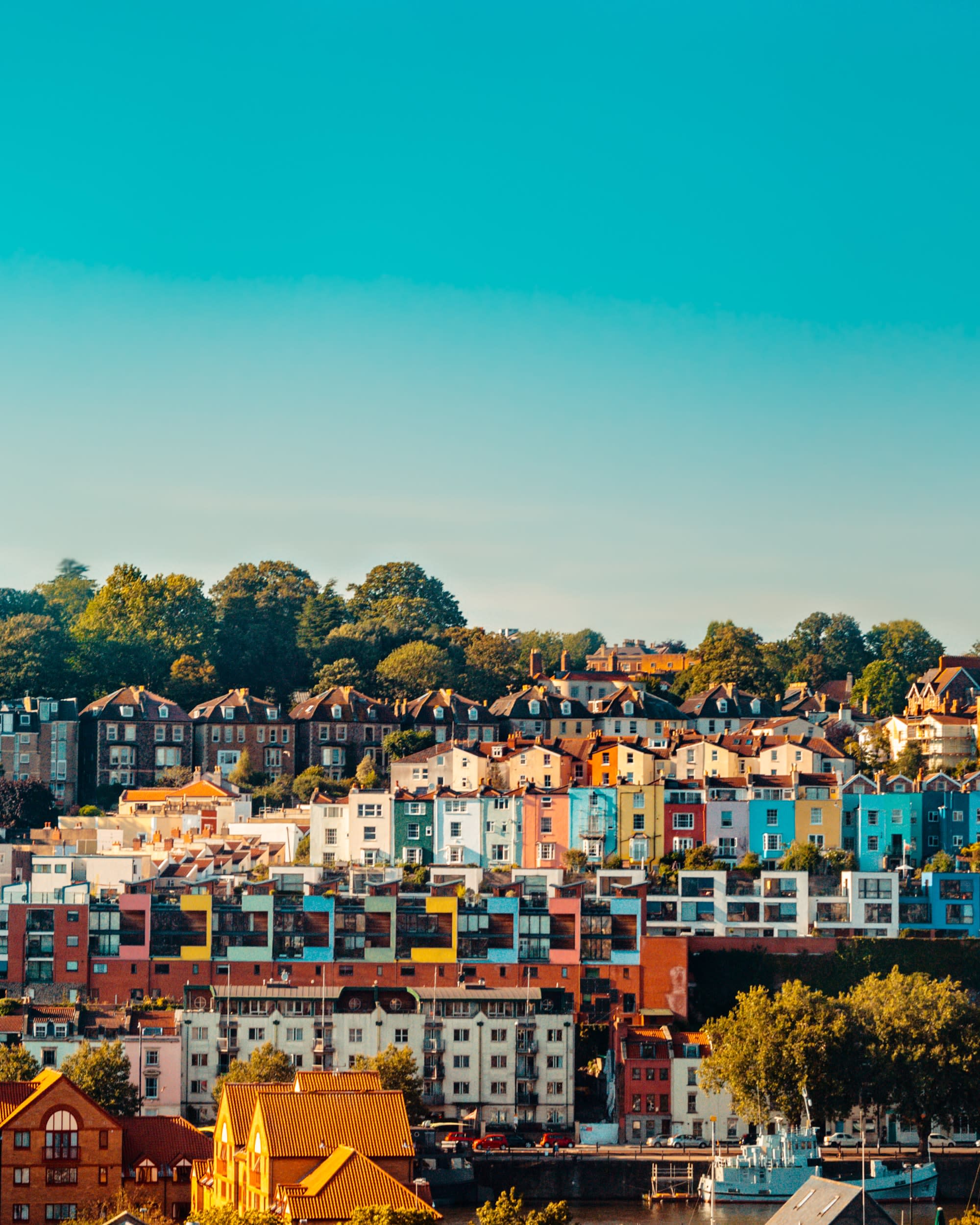 multi-colored houses on a hill with blue sky