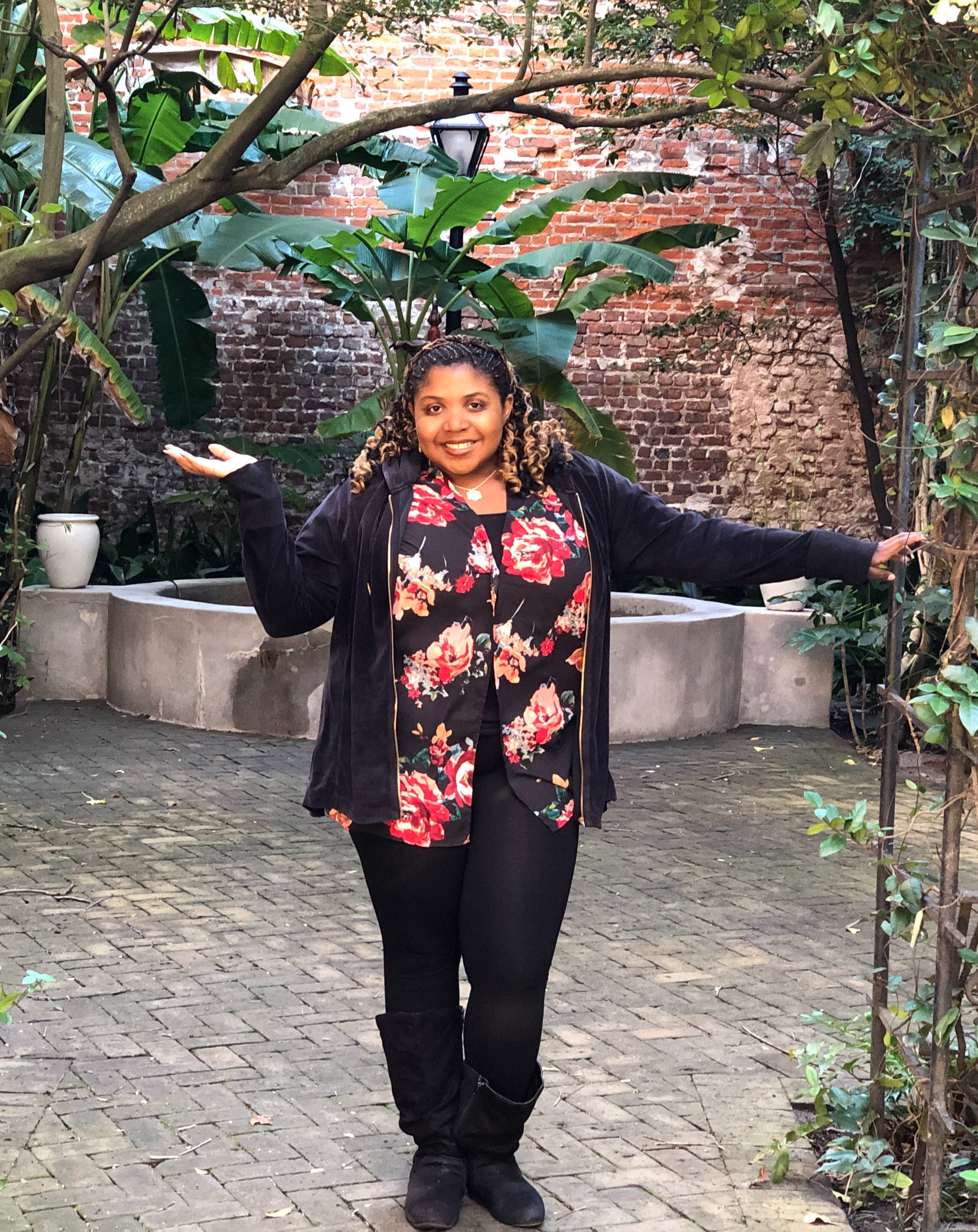 Advisor posing in a courtyard area