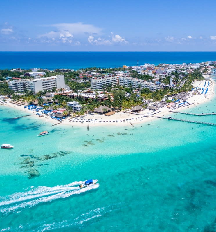 Aerial view of an island surrounded by bright blue water during the daytime