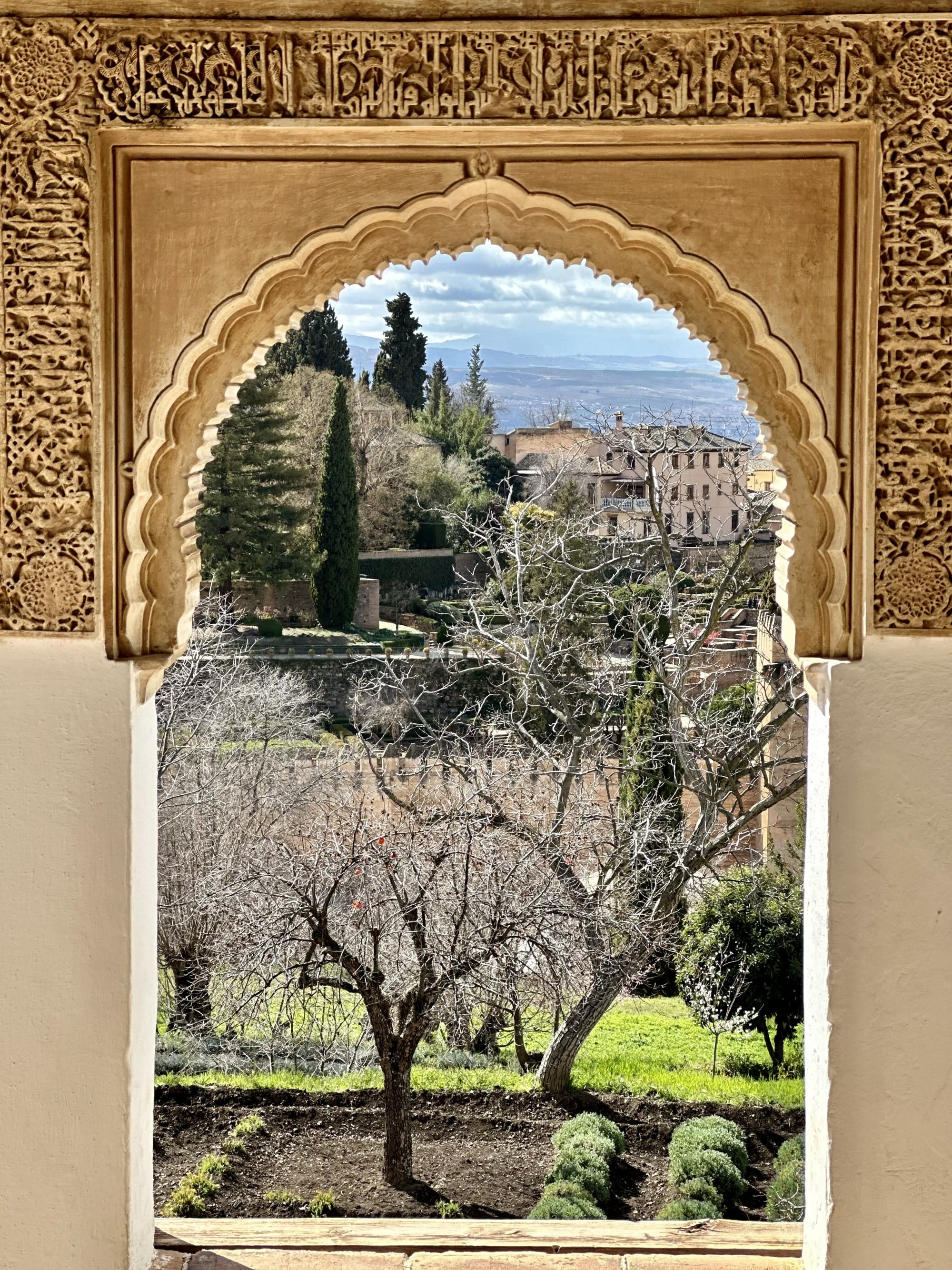 View of city from inside a golden arch.