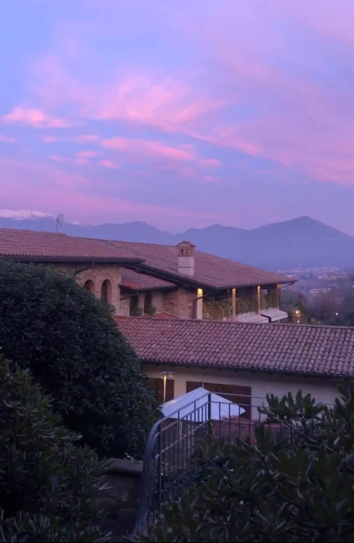 A view from the top of the mountains in Lombardy, overlooking a lake.