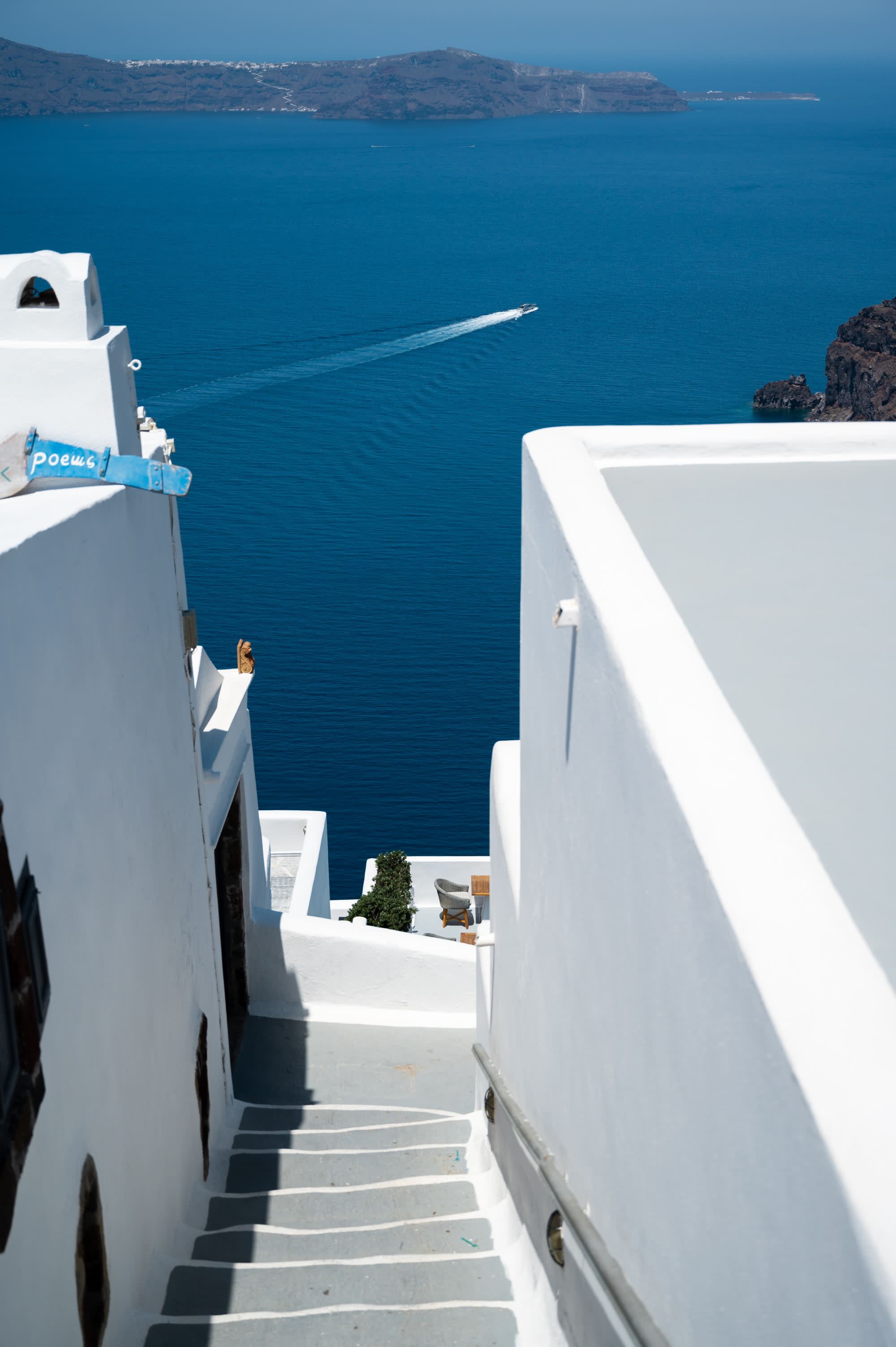 royal blue water below a white city