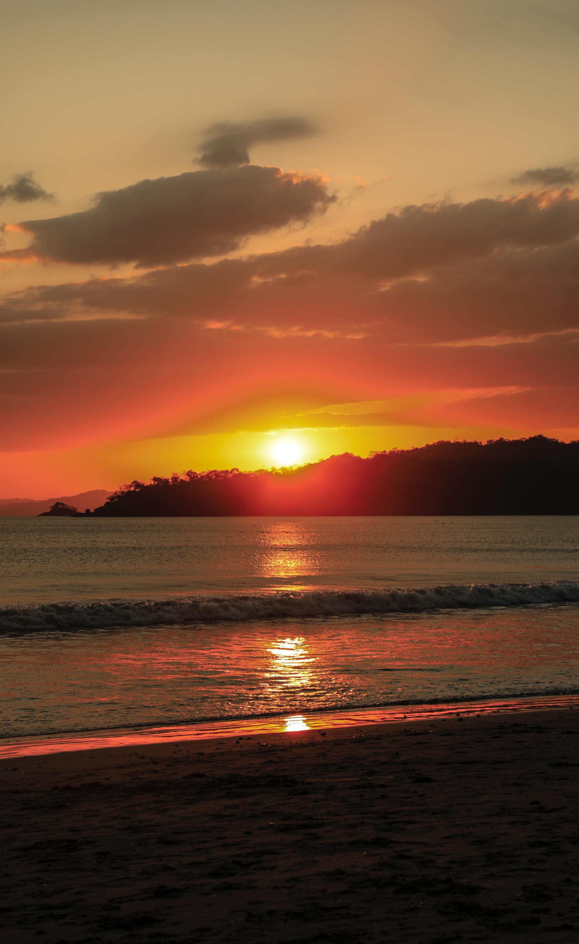 vibrant orange sunset over a calm beach