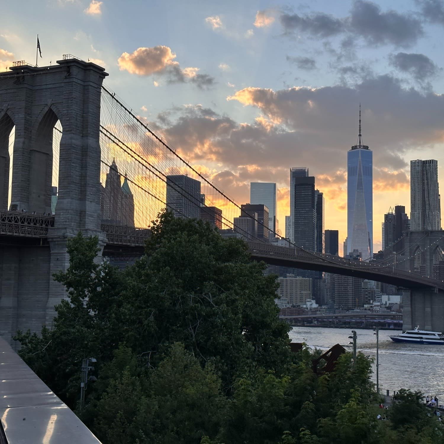 City skyline behind a bridge.