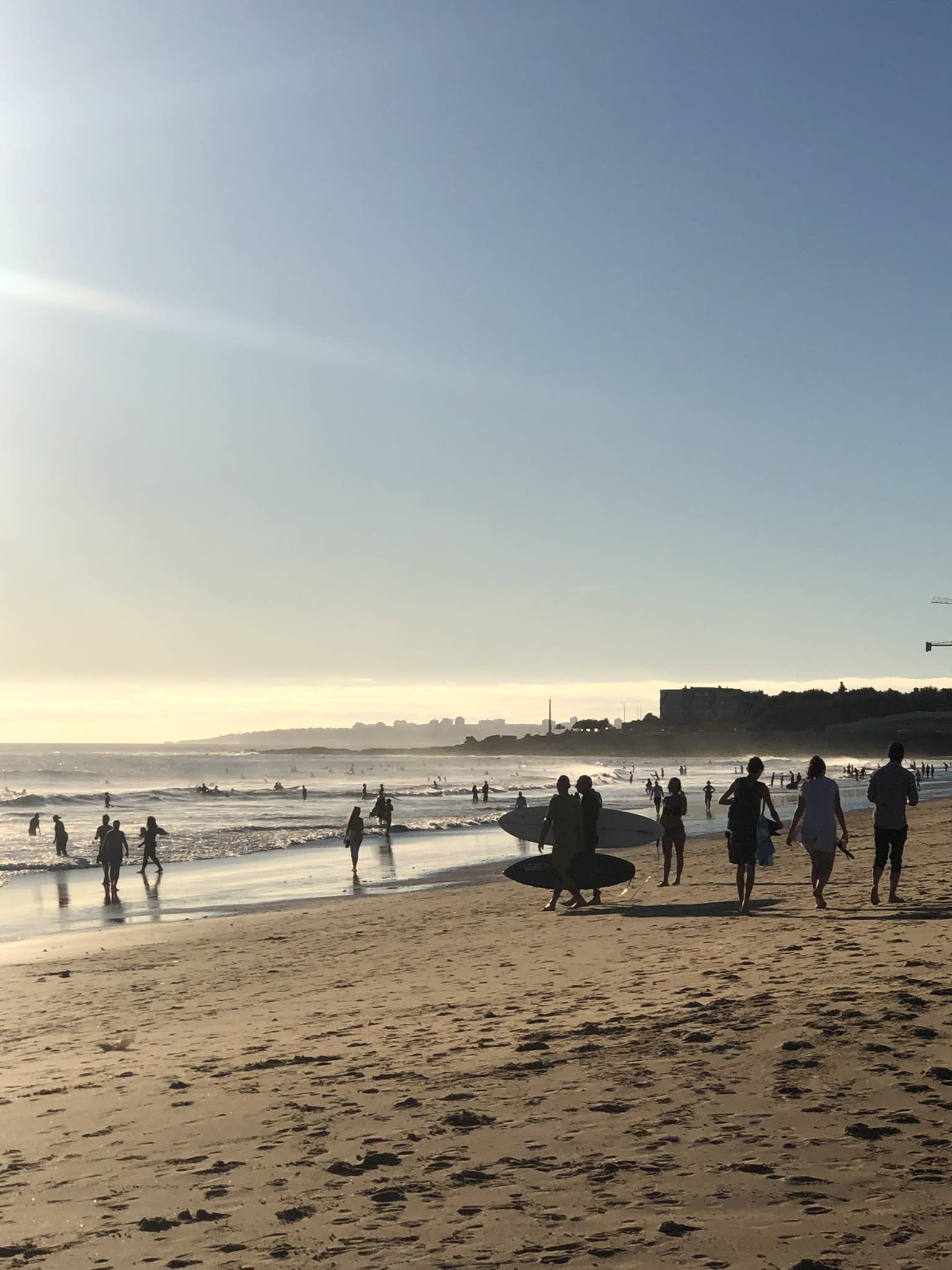 A beach filled with surfers in Lisbon.