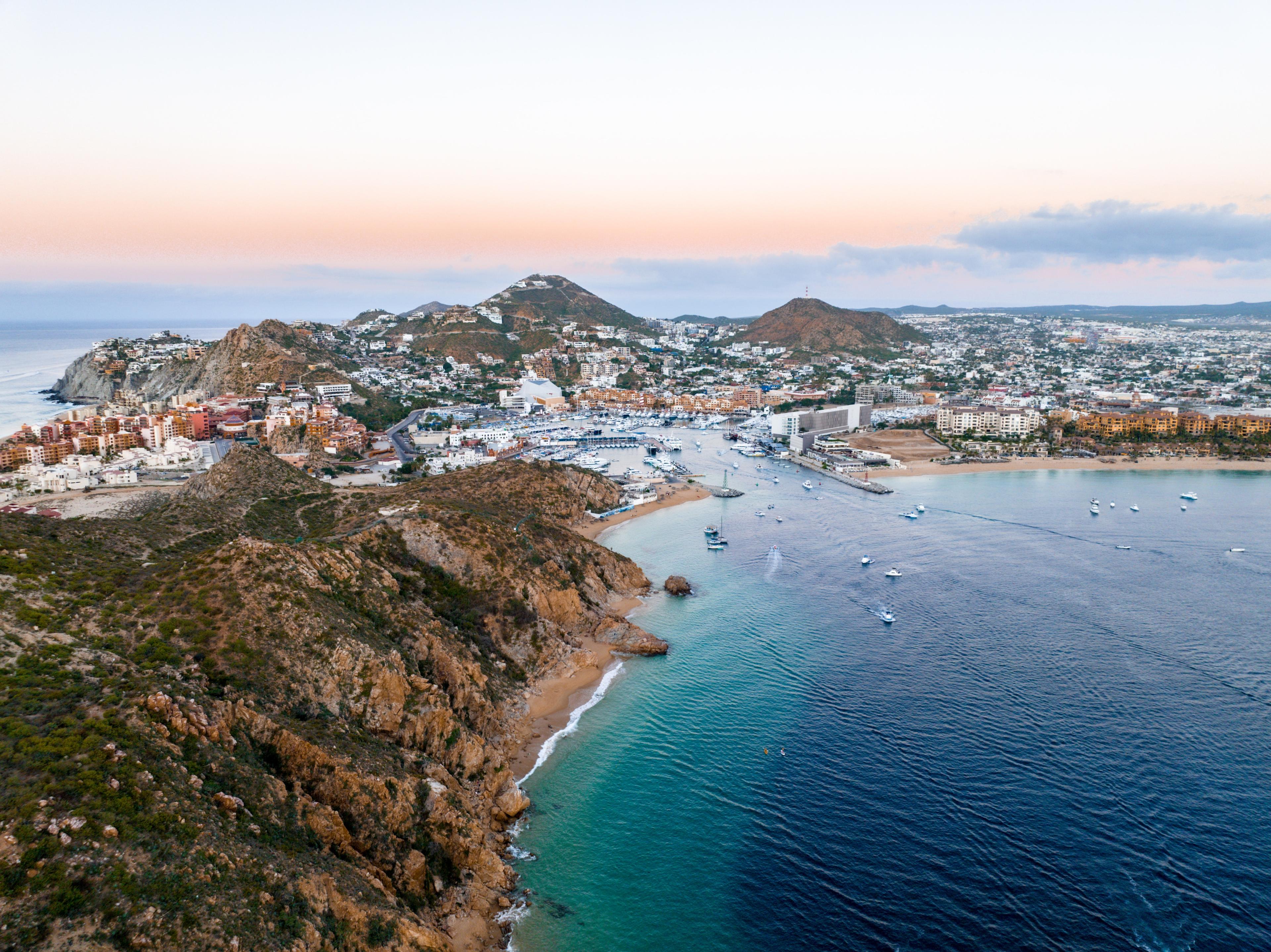 aerial view of land next to body of water during sunset