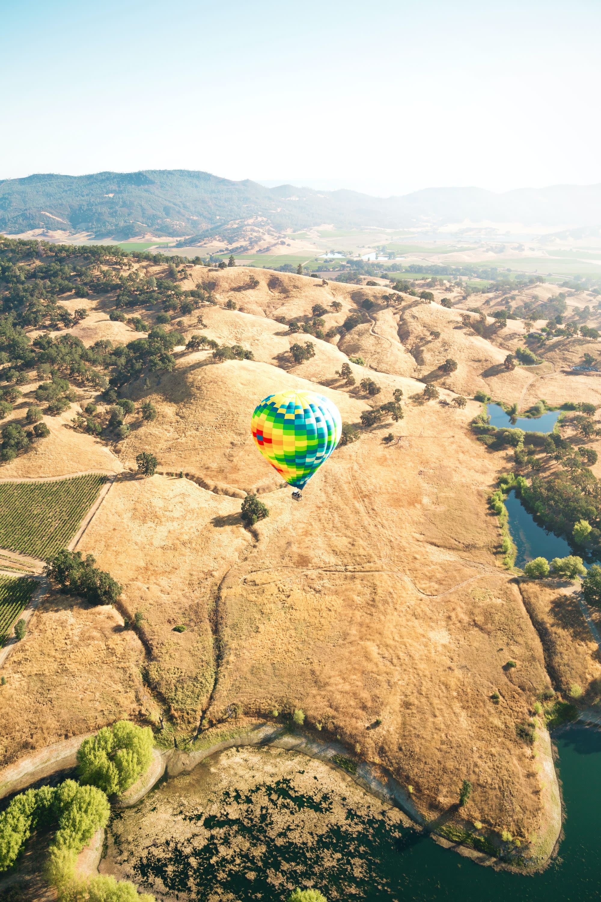 Hot air ballon over mountains during daytime.