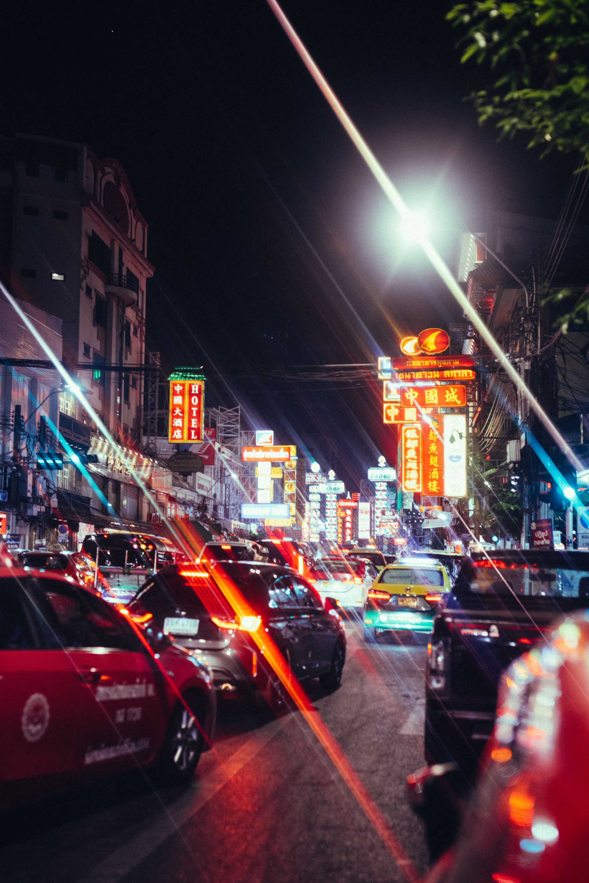 A city street filled with lots of traffic at night.