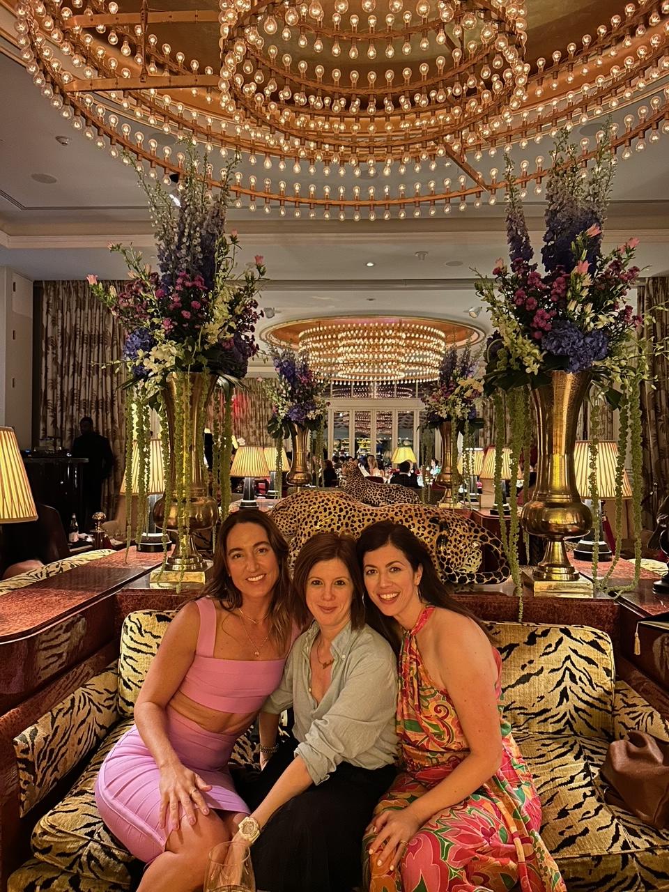 Three women posing on a couch in doors