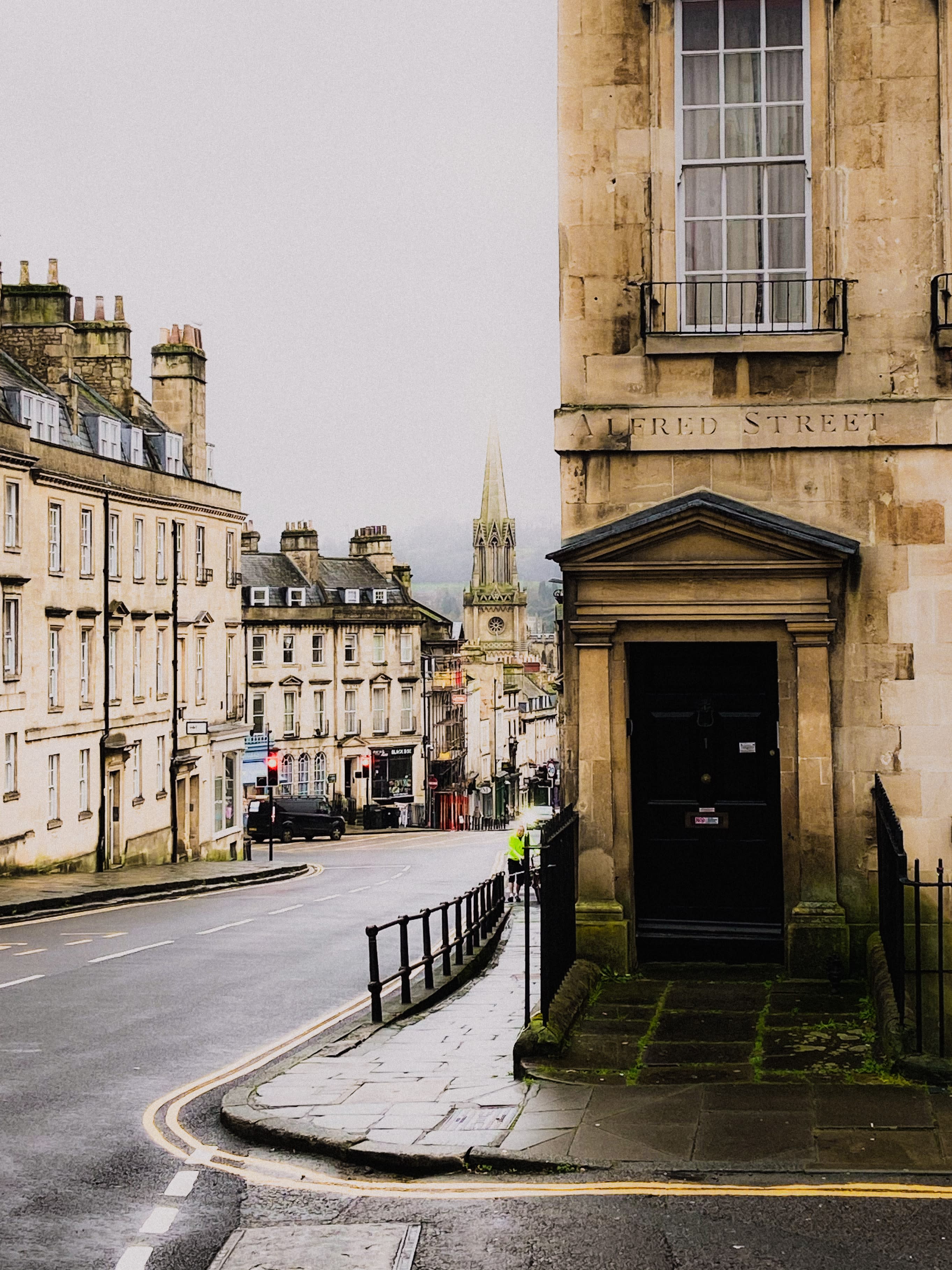 street lined with stone buildings with gray skies