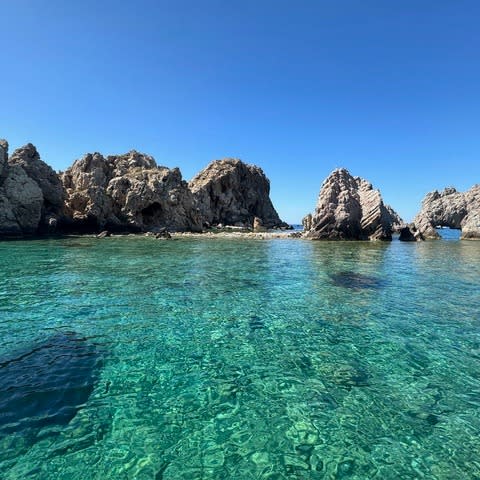 Rock formations on green water.
