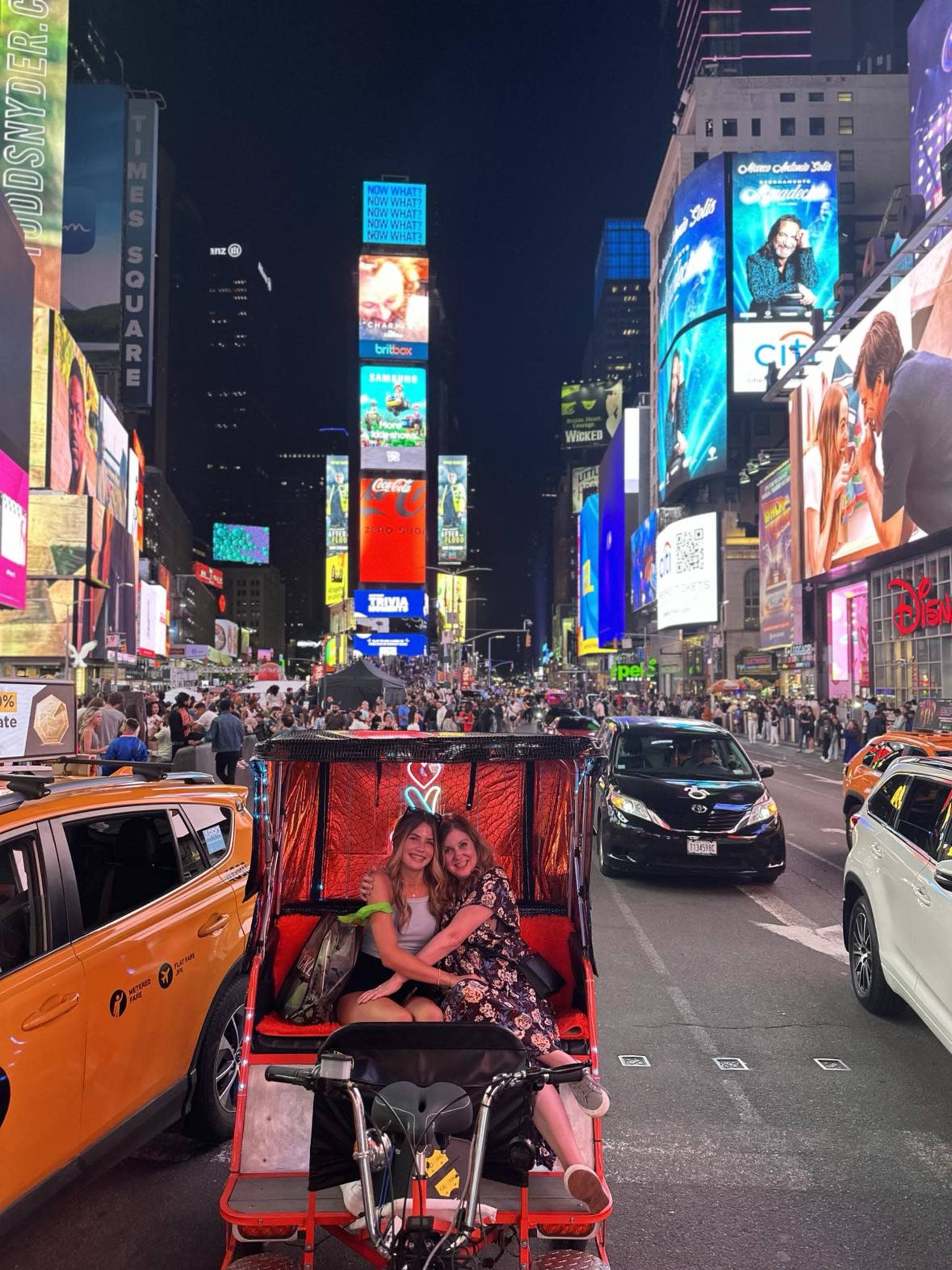 Amidst the vibrant lights of Times Square, a Tuk-Tuk carries its passengers through the city’s electric pulse.