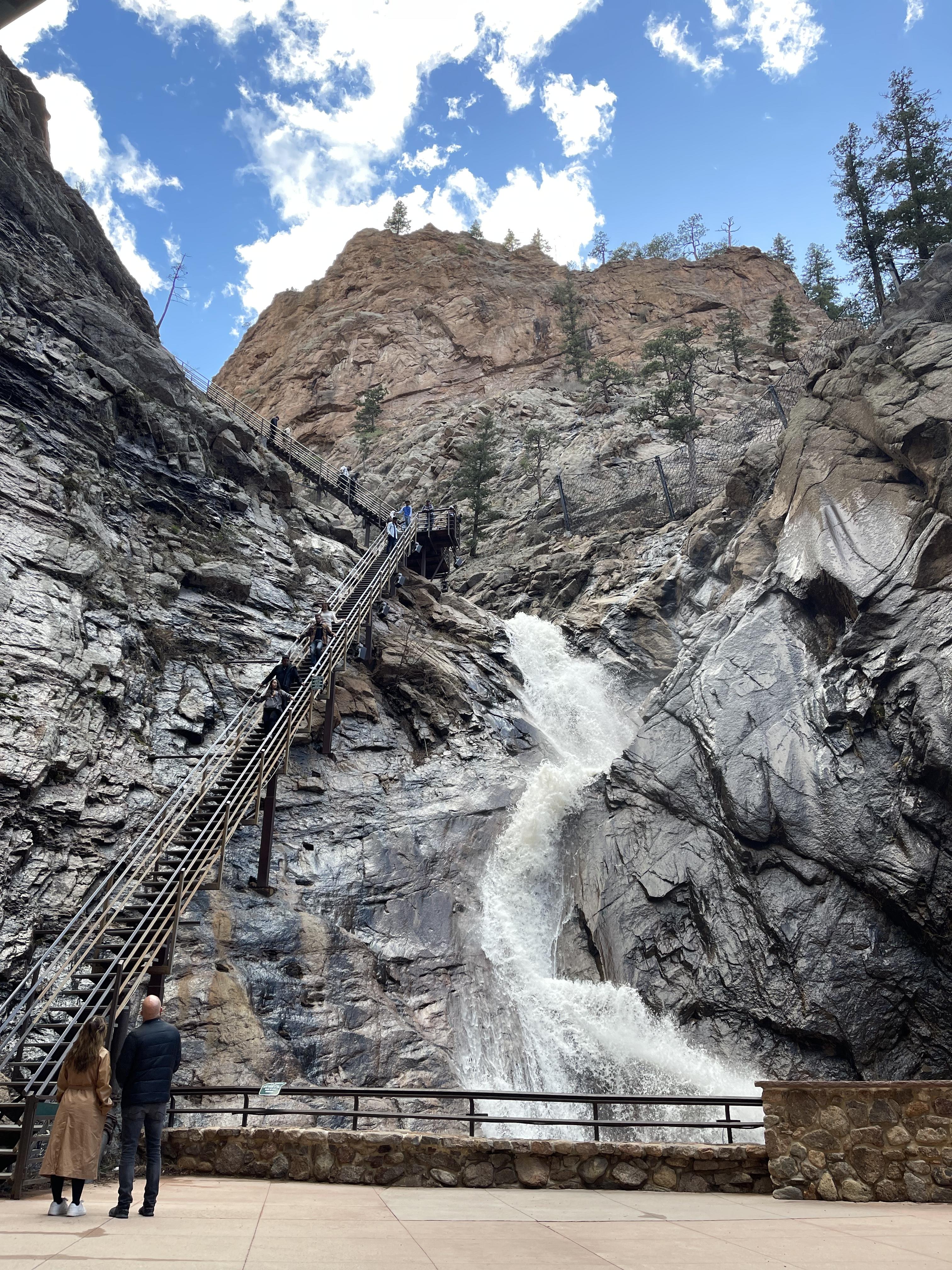 A waterfall down a mountain during the daytime