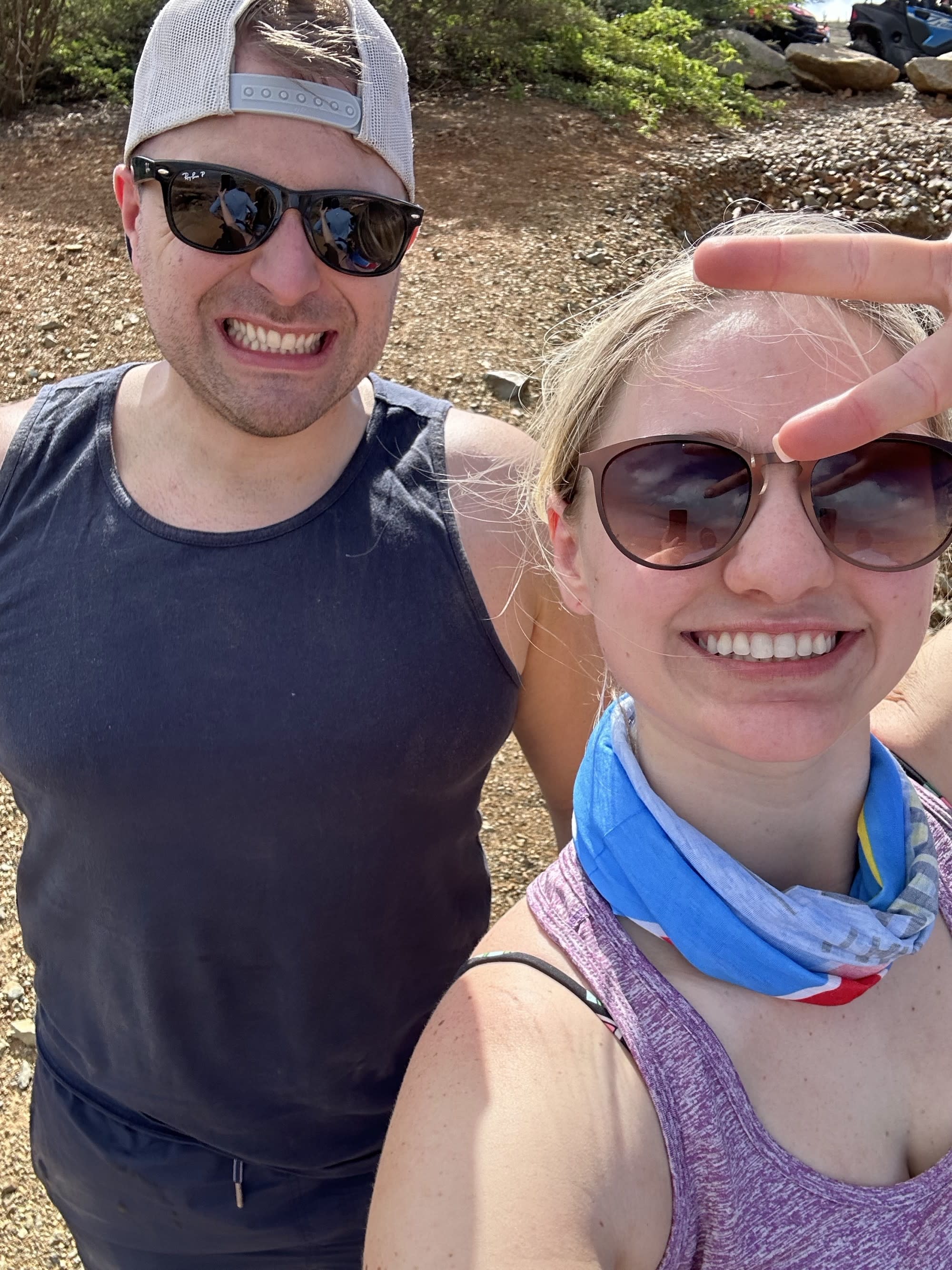 A couple outdoors posing for a selfie.