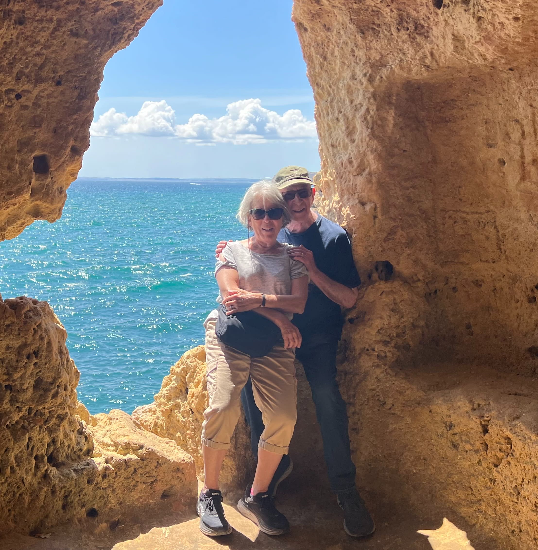 Rita and her husband posing in a cave at Vila Nova de Gaia beach