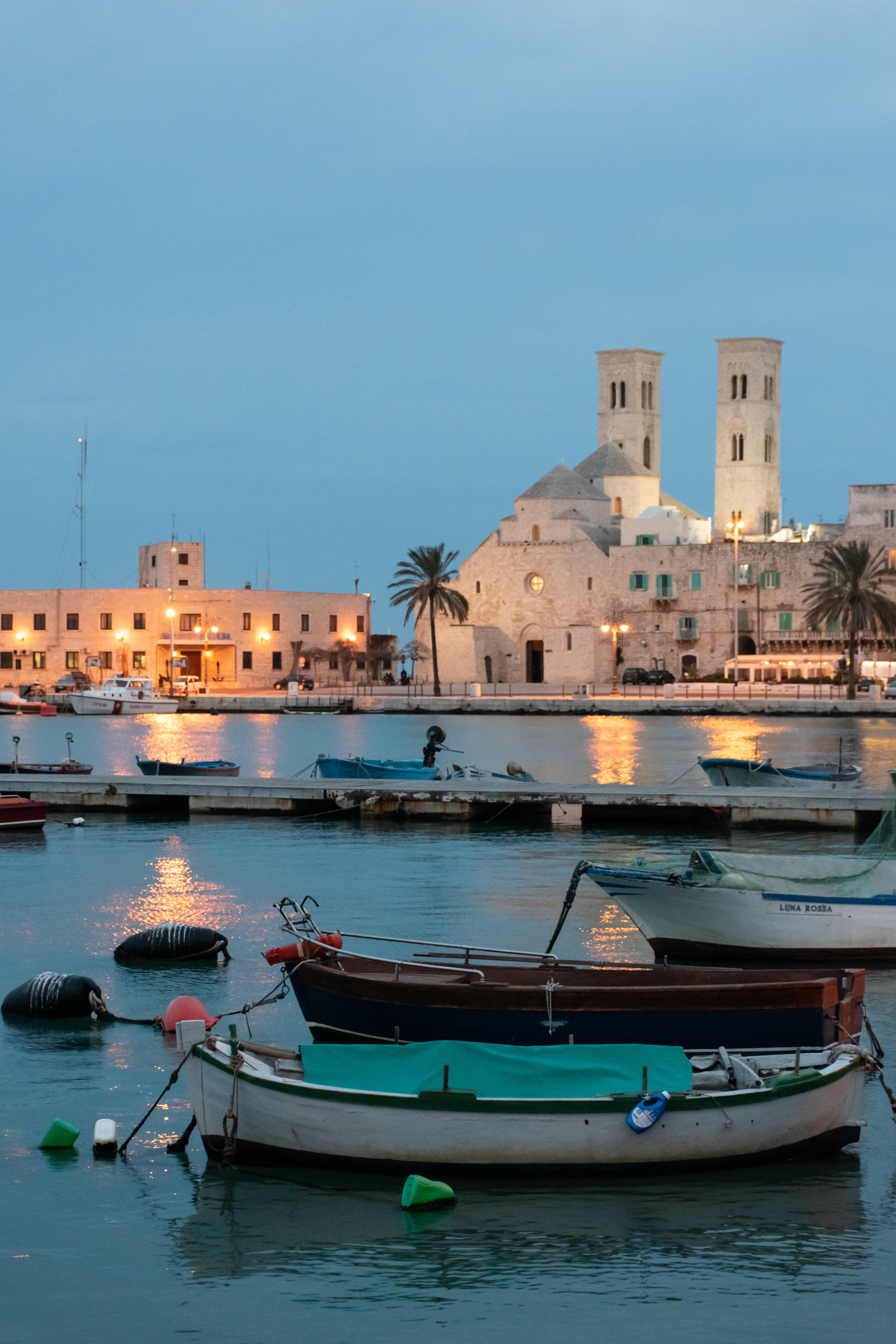 Boats floating in the sea and city on the other side.