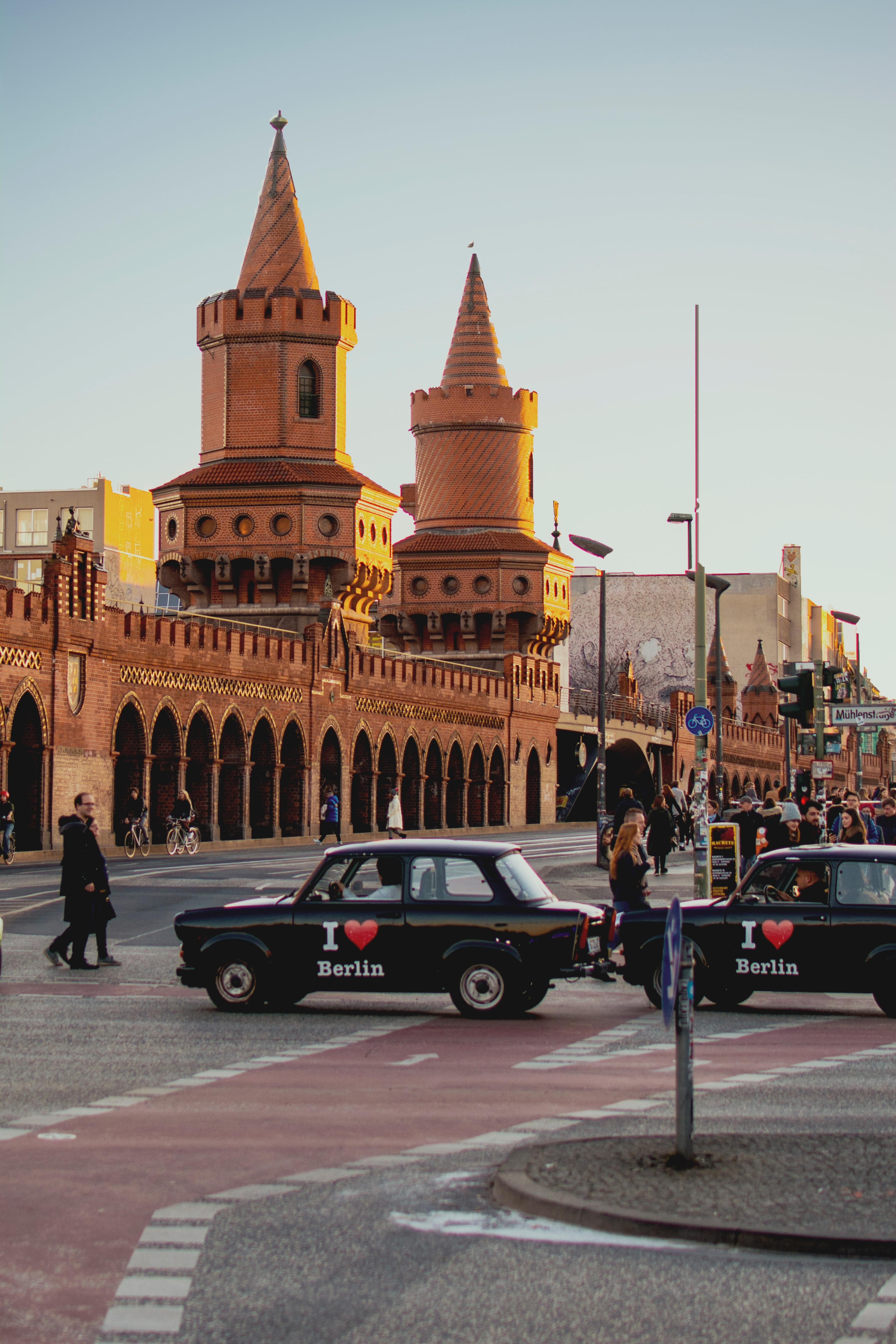 Yellow building and cars with pedestrians in Berlin